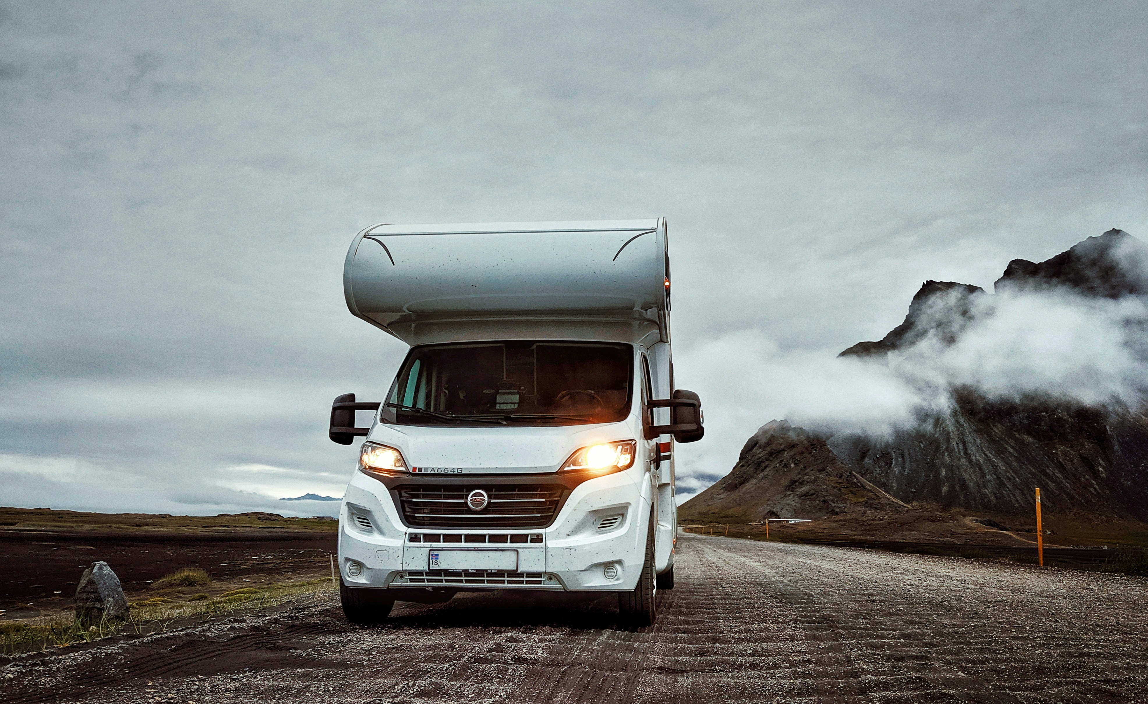 Large motorhome on a scenic Icelandic road with glacier views